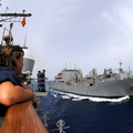 Press center us navy 100603 n 0553r 071 lt. cmdr. samantha farriker watches from the port bridge wing as the military sealift command dry cargo and ammunition ship usns robert e. peary  t ake 5  pulls along side